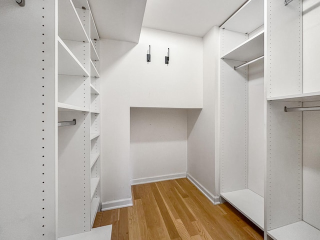 spacious closet with light hardwood / wood-style floors