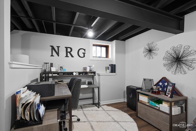 office space featuring beamed ceiling, baseboards, and wood finished floors