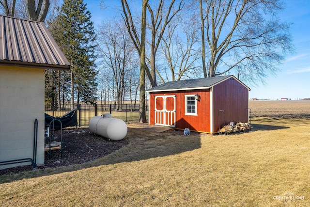 view of shed featuring fence