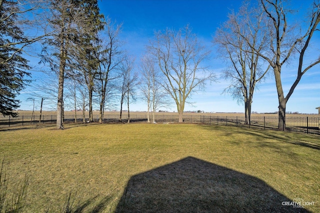 view of yard with a rural view and fence