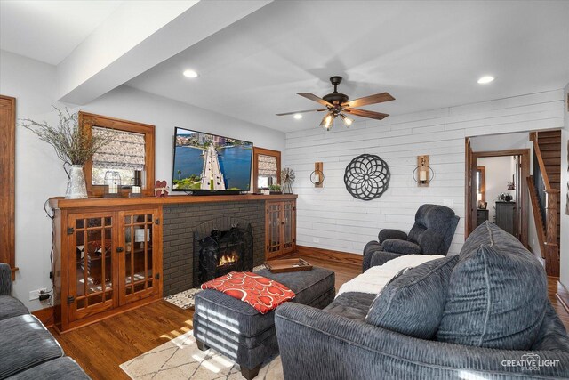 kitchen featuring stainless steel stove, tasteful backsplash, black dishwasher, white cabinets, and light stone counters