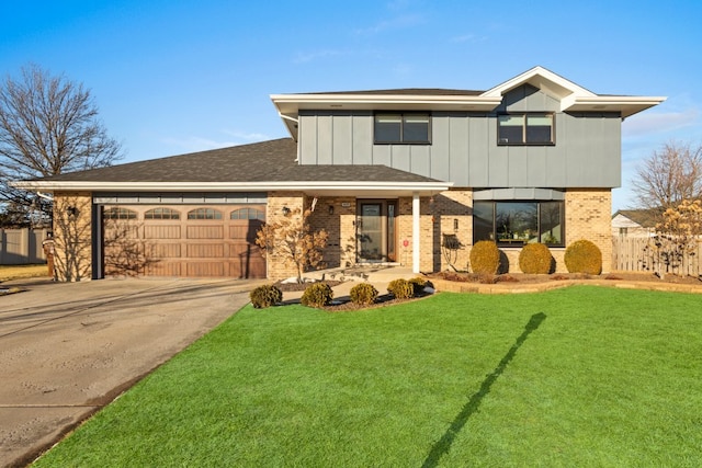 view of front of home with a garage and a front lawn