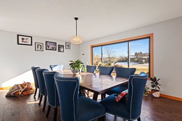 dining space featuring dark hardwood / wood-style floors and a notable chandelier