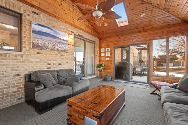 carpeted living room with high vaulted ceiling, a skylight, wooden ceiling, and ceiling fan