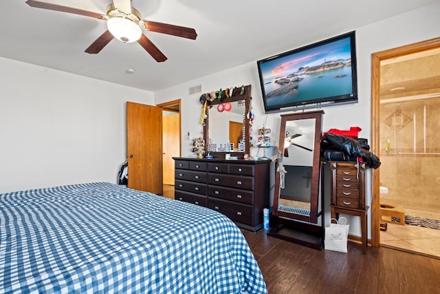 bedroom with dark wood-type flooring, ceiling fan, and ensuite bathroom