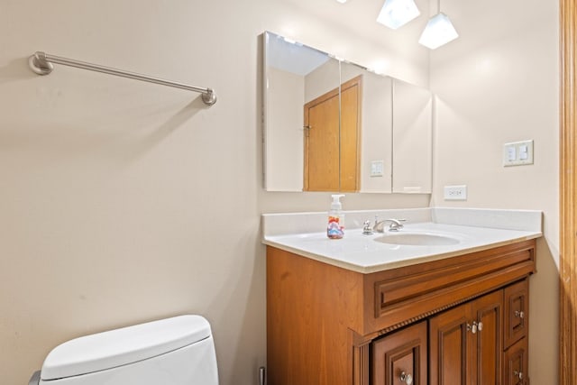 bathroom featuring vanity, a skylight, and toilet