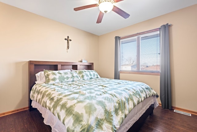 bedroom with dark hardwood / wood-style floors and ceiling fan