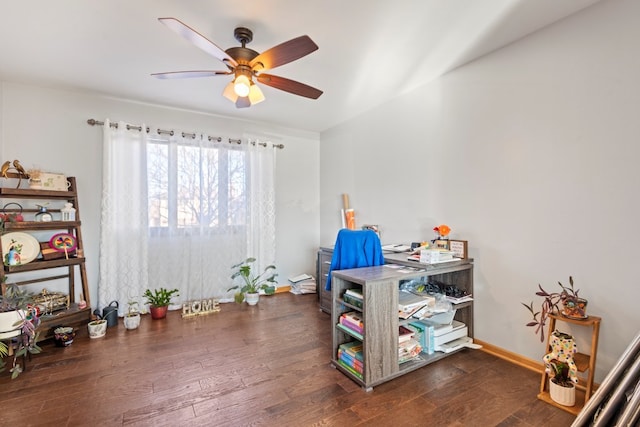 misc room with dark wood-type flooring and ceiling fan