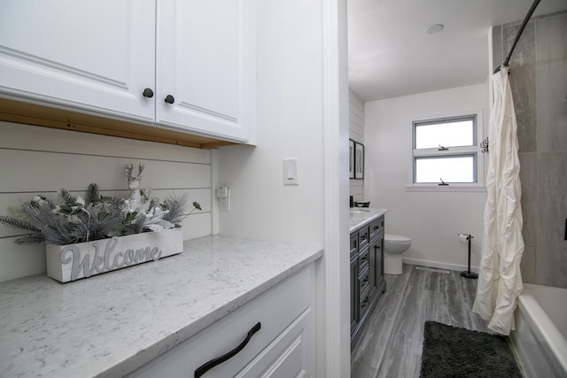 full bathroom with hardwood / wood-style flooring, vanity, toilet, and shower / bath combo with shower curtain