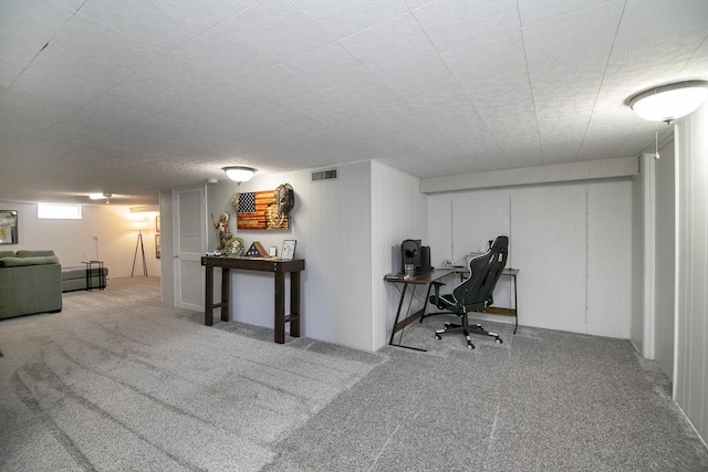 carpeted office space featuring a textured ceiling