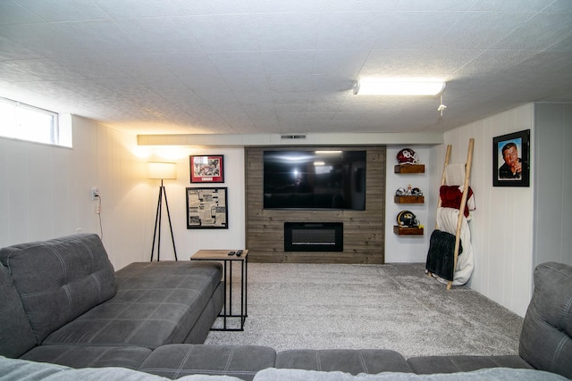 living room featuring carpet floors and a large fireplace