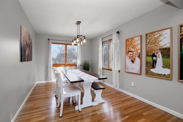 dining area featuring a chandelier and light hardwood / wood-style flooring