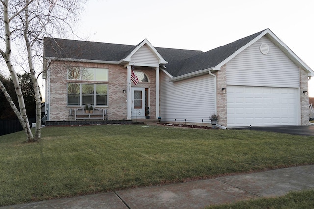 view of front of house featuring a garage and a front lawn