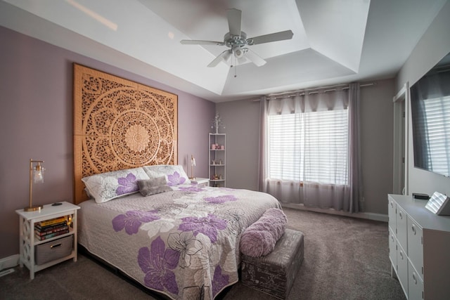 bedroom featuring a raised ceiling, carpet flooring, and ceiling fan