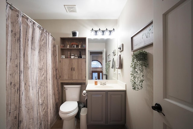 bathroom featuring vanity and toilet