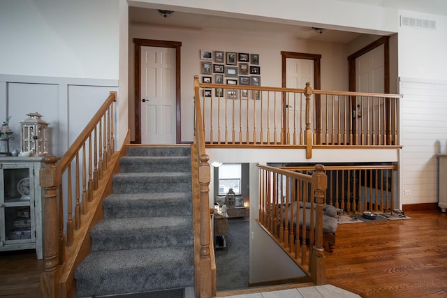 staircase with hardwood / wood-style floors