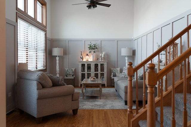 living room with hardwood / wood-style floors and ceiling fan