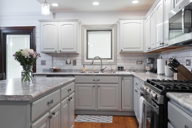 kitchen featuring stainless steel appliances, white cabinetry, sink, and dark hardwood / wood-style floors