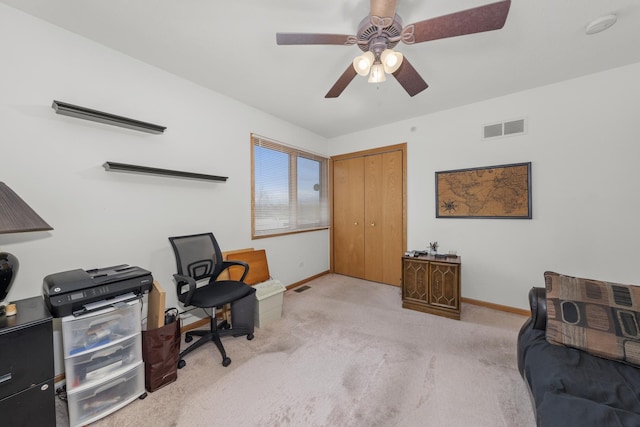 home office featuring light carpet and ceiling fan