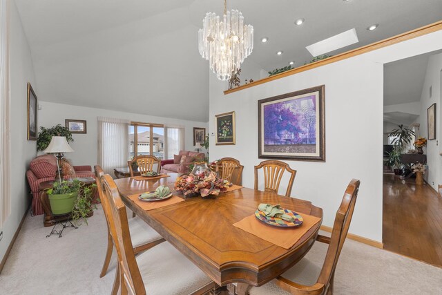 dining room featuring light carpet, a notable chandelier, and a towering ceiling