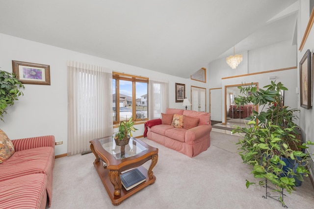 living room with vaulted ceiling, light colored carpet, and a chandelier