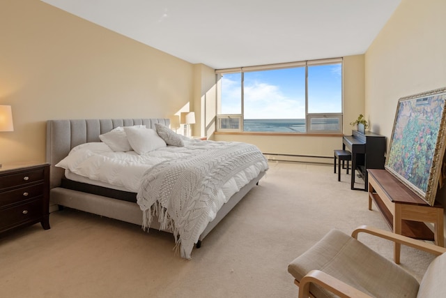 carpeted bedroom featuring baseboard heating and a water view