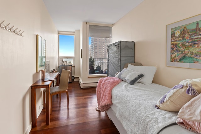 bedroom with a baseboard radiator and dark hardwood / wood-style floors