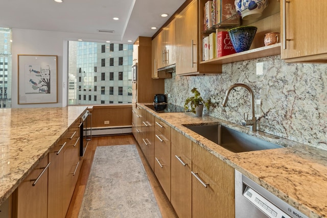 kitchen with light stone counters, sink, stainless steel dishwasher, and black electric cooktop