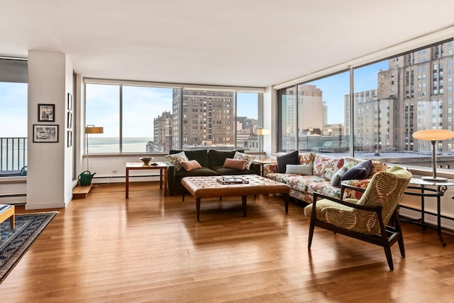 sunroom featuring a wealth of natural light and a baseboard heating unit