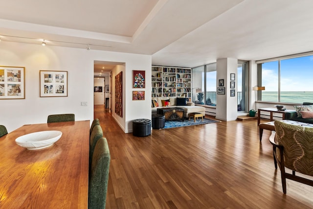 dining room featuring a water view and hardwood / wood-style flooring