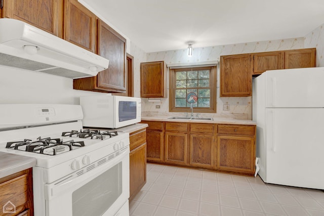 kitchen with sink and white appliances