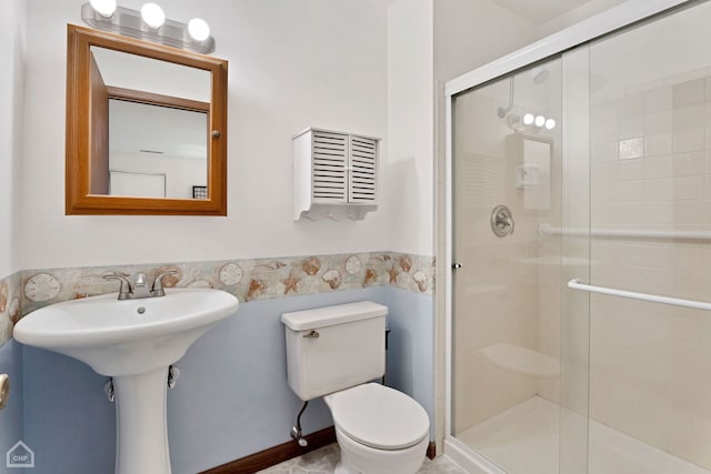 bathroom with walk in shower, sink, and toilet