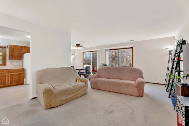 carpeted living room featuring ceiling fan