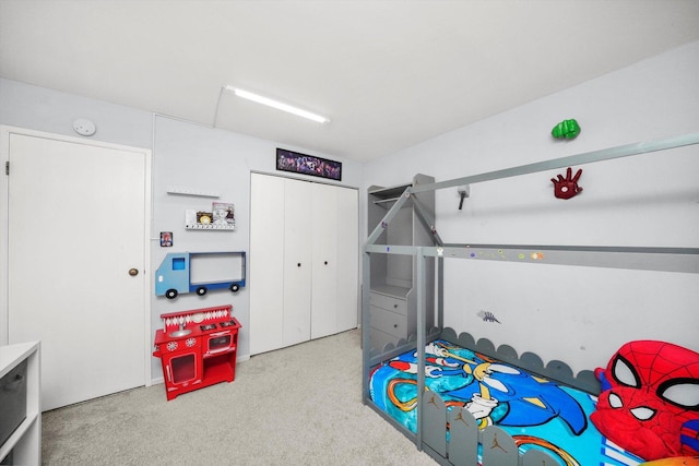 bedroom with light colored carpet and a closet