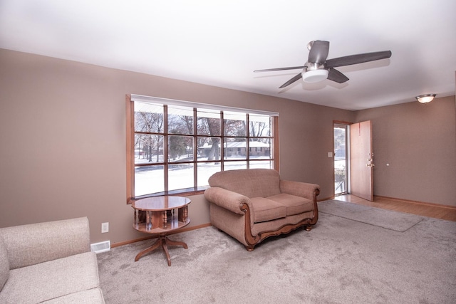 living room featuring ceiling fan and light colored carpet