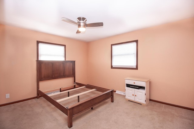 unfurnished bedroom with light colored carpet and ceiling fan