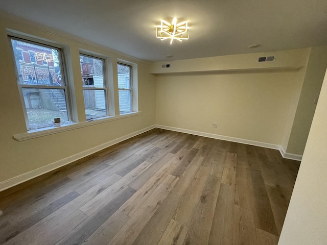 spare room with wood-type flooring