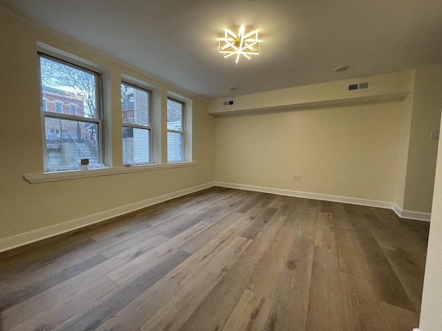 unfurnished room with wood-type flooring