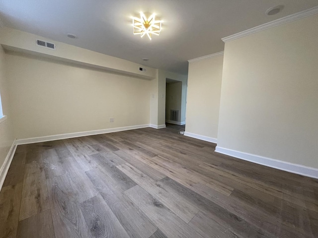 unfurnished room with wood-type flooring and ornamental molding