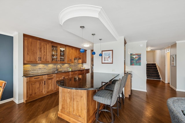 bar with dark hardwood / wood-style flooring, decorative light fixtures, ornamental molding, and decorative backsplash