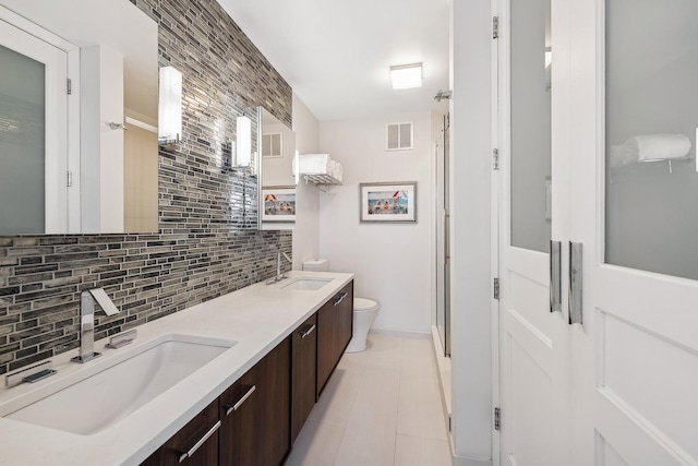 kitchen featuring sink, decorative backsplash, dark brown cabinets, and light tile patterned floors