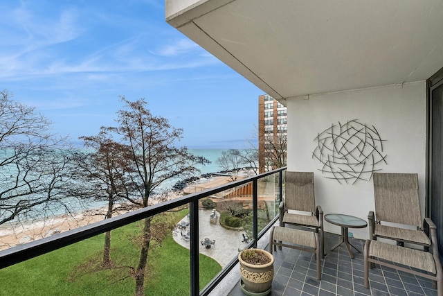 balcony with a view of the beach and a water view