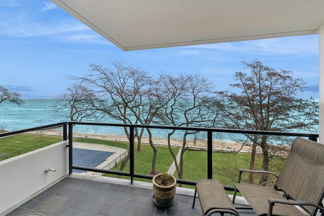 balcony with a view of the beach and a water view