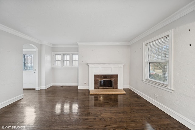 unfurnished living room featuring dark hardwood / wood-style flooring, a fireplace, and ornamental molding