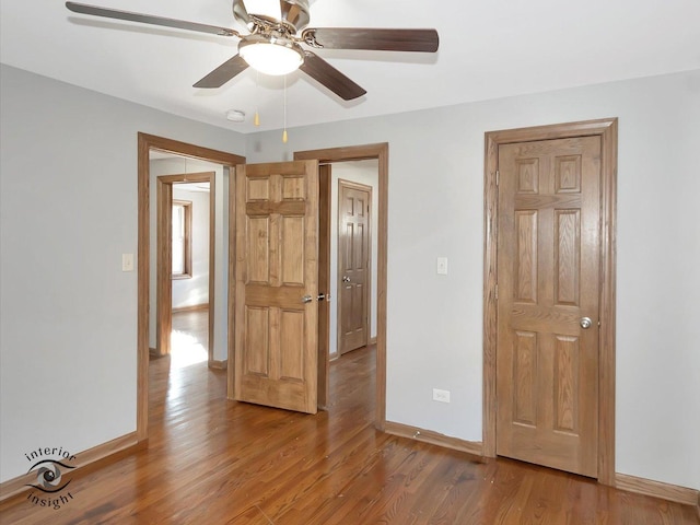 empty room featuring wood-type flooring and ceiling fan