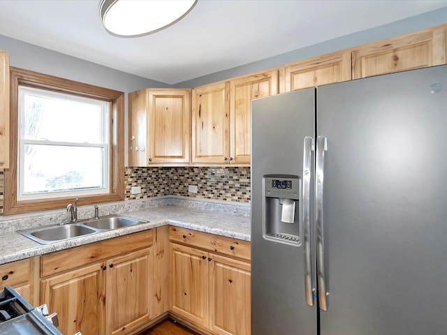 kitchen with tasteful backsplash, sink, light brown cabinets, and stainless steel refrigerator with ice dispenser