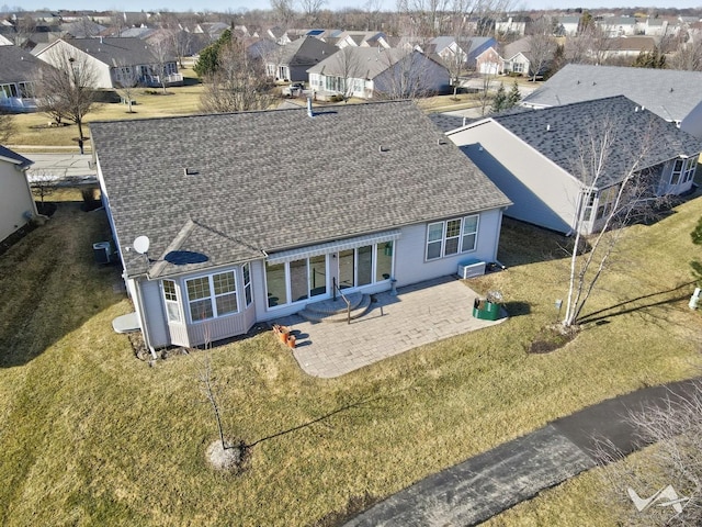 back of house with a shingled roof, a patio area, a residential view, and central air condition unit