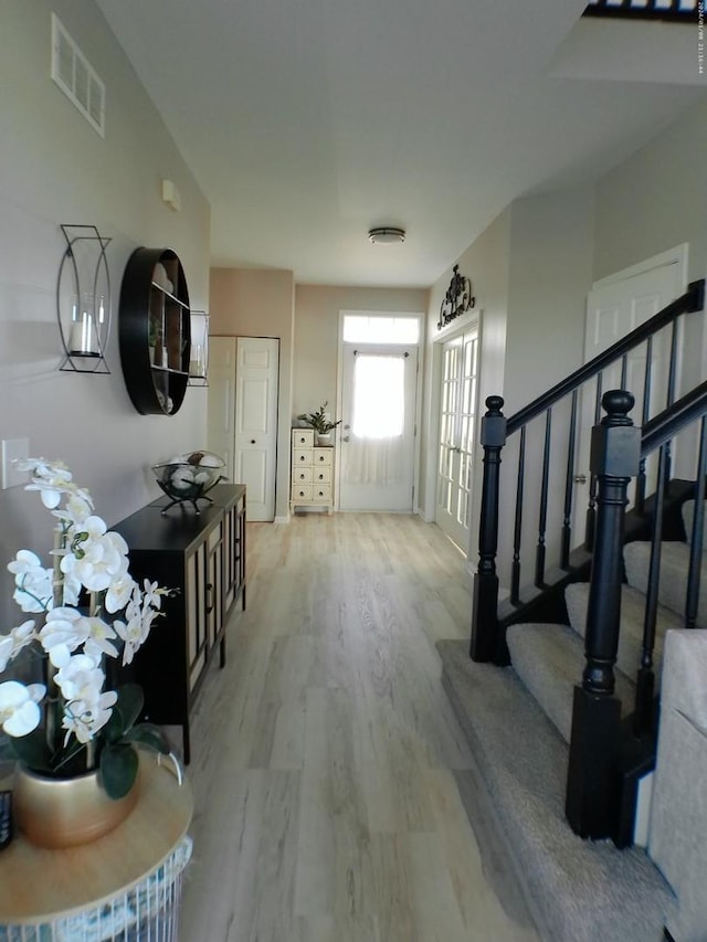 entryway with light hardwood / wood-style flooring