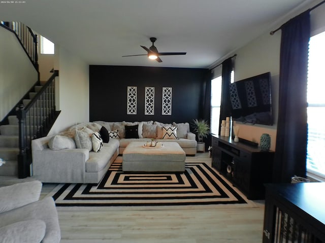 living room featuring hardwood / wood-style flooring and ceiling fan