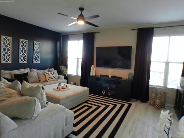 living room with light hardwood / wood-style floors and ceiling fan